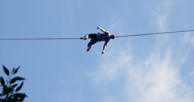 Man Balancing on Tightrope Against Blue Sky - Download Free Stock Images Pikwizard.com