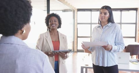 Diverse Female Coworkers Collaborating in Open Office