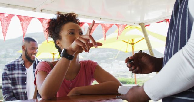 Woman Ordering at Outdoor Concession Stand - Download Free Stock Images Pikwizard.com