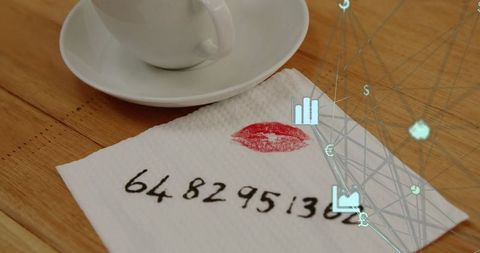 Coffee cup by napkin with lipstick mark and written number overlay