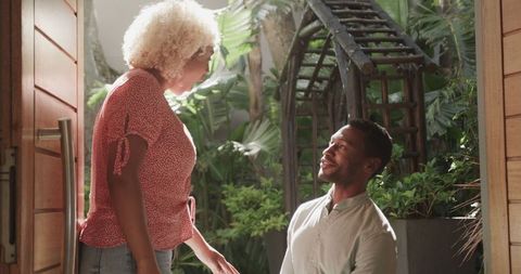 Joyful marriage proposal in lush garden setting