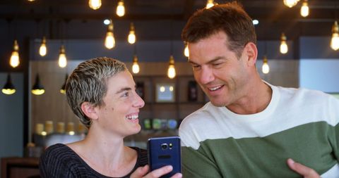 Casual business colleagues laughing together in cafe