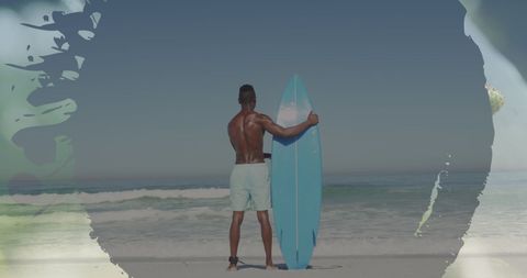 Surfer Holding Blue Surfboard Gazing at Ocean