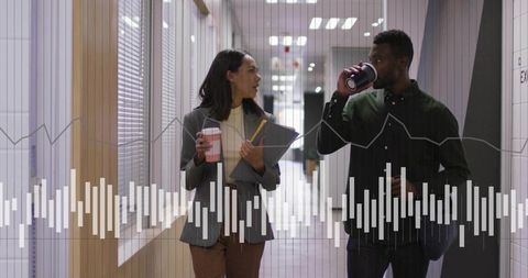 Colleagues Engaging in Work Discussion Over Coffee in Hallway