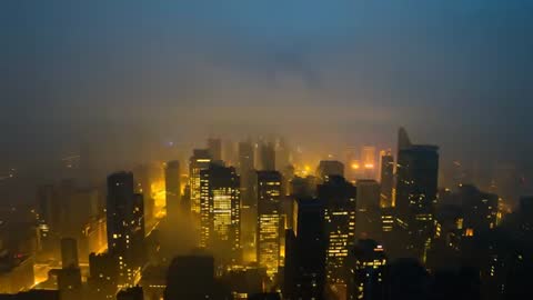 Mysterious Cityscape with Skyscrapers Soaring through Night Fog