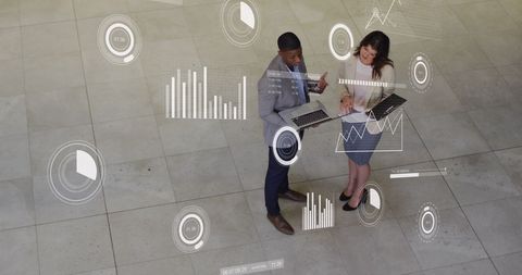 Digital Data Analysis Meeting Between Colleagues in Office Environment