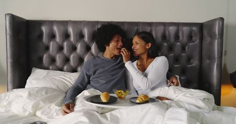 Cozy Romantic Breakfast in Bed with Diverse Couple