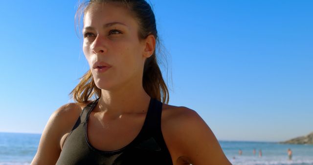 Young Woman in Sportswear Exercising at Beach - Download Free Stock Images Pikwizard.com