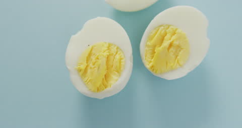 Hard-Boiled Egg Halves on Blue Background