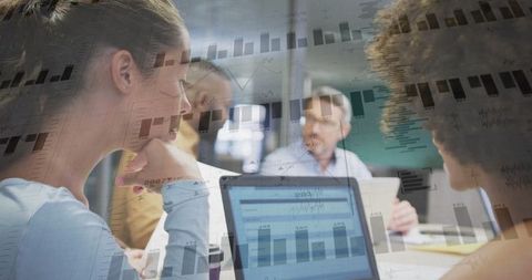 Business Team Collaborating Over Data Analysis in Meeting Room