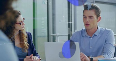 Analytics Expert Discussing Metrics with Technology Visuals in Office