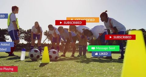Youth female soccer team practicing drills with social media overlays in backlit field