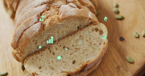 Sliced artisanal sourdough loaf resting on wooden board with eco data overlay and seeds