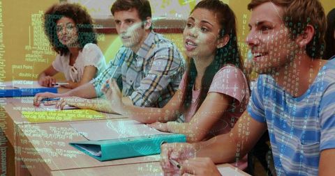 College students taking notes, collaborating in coding class with turquoise binder