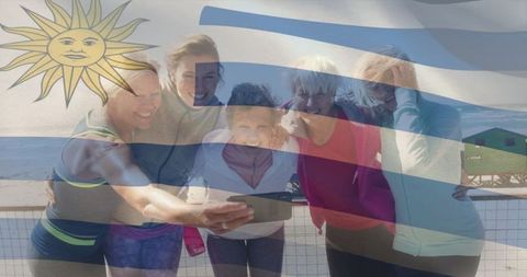 Group of senior women enjoying selfie moment on beach