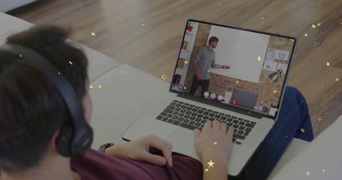 Teenager attending virtual lesson with laptop on sofa