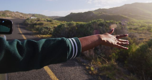 Hand Reaching Out from Car Window on Scenic Road Trip - Download Free Stock Images Pikwizard.com