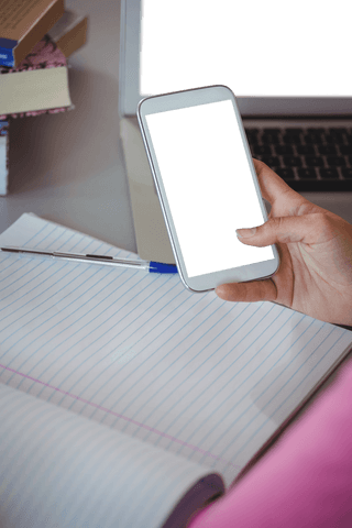 transparent smartphone over notebook in educational setting - Download Free Stock Videos Pikwizard.com