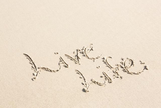 Inspirational message 'Live Life' written on sand at beach. Ideal for motivational posters, travel blogs, vacation advertisements, and social media posts promoting positivity and relaxation.