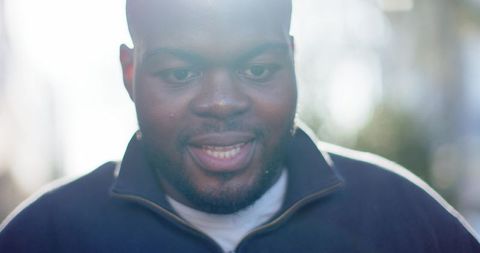 African american man speaking outdoors backlit portrait with rimlight and soft bokeh