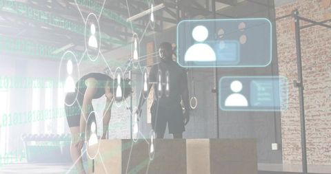 Athlete catching breath with trainer in industrial crossfit gym overlaid with digital hud