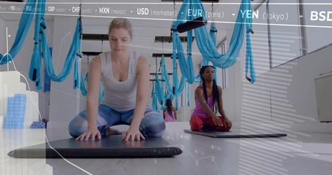 Women Practicing Relaxation and Flexibility in Aerial Yoga Studio