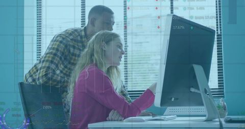 Focused Colleagues Analyzing Data on Computer at Office