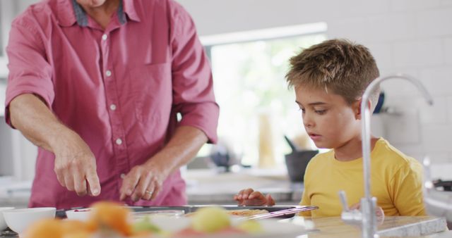 father cooking with young son in modern kitchen - Download Free Stock Images Pikwizard.com