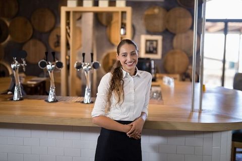 Smiling Female Bartender in Rustic Brewery Setting - Download Free Stock Images Pikwizard.com