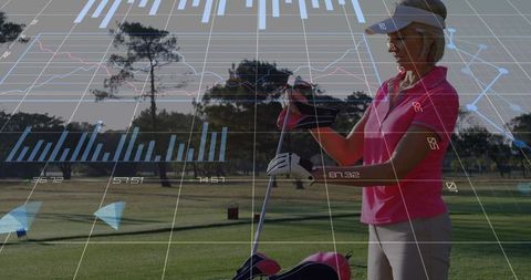 Senior Female Golfer Adjusting Club in Sunlit Golf Course