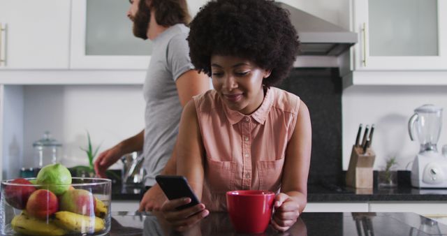 Woman Relaxing in Kitchen with Coffee and Smartphone - Download Free Stock Images Pikwizard.com