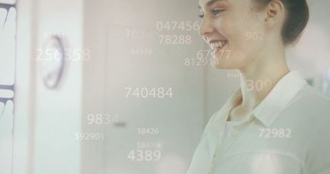 Woman in modern office analyzing digital data with augmented reality