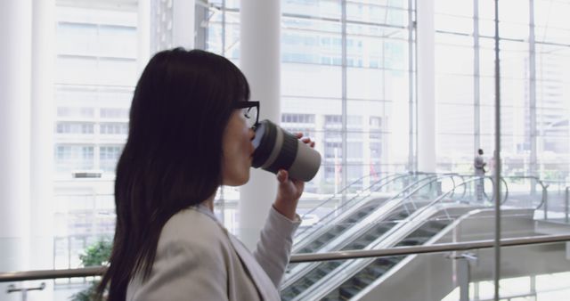 Businesswoman Drinking Coffee in Modern Office Building - Download Free Stock Images Pikwizard.com