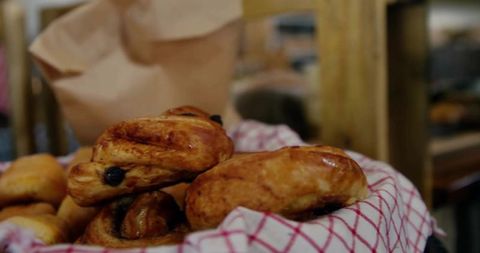 Freshly baked raisin pastries in rustic bakery basket