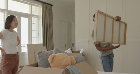 Couple Arranging New Home with Excitement and Teamwork