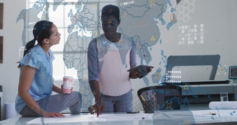 Diverse Businesswomen Analyzing Global Data in Office