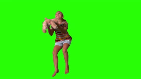 Child Joyfully Jumping with Teddy Bear on Green Screen