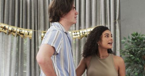 Interracial Couple Arranging Birthday Party Decorations at Home