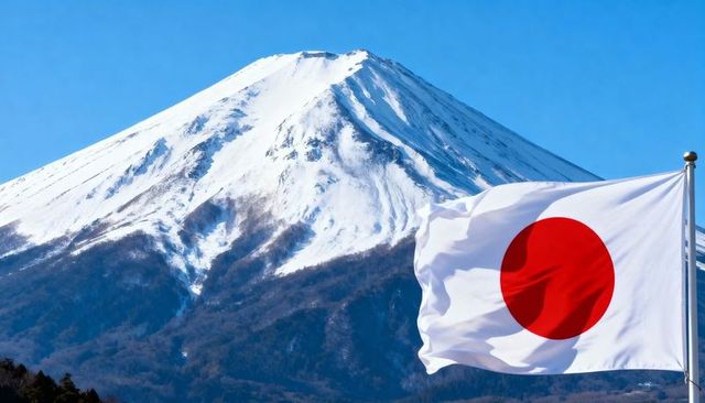 Waving japanese flag framing snow-capped mount fuji under clear blue sky