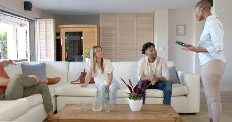 Diverse Friends Socializing with Technology at Cozy Home Gathering