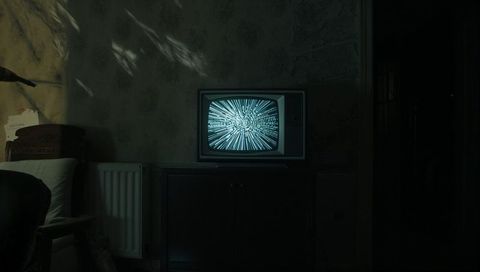 Vintage CRT Television in Dimly Lit Abandoned Room