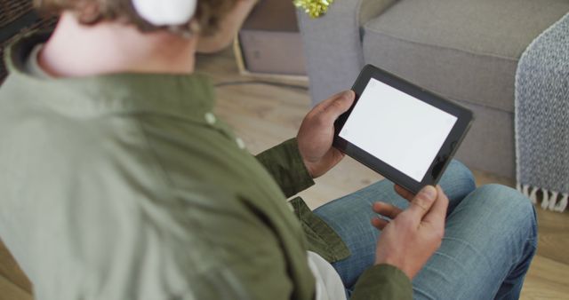 Young Man Using Tablet in Living Room - Download Free Stock Images Pikwizard.com