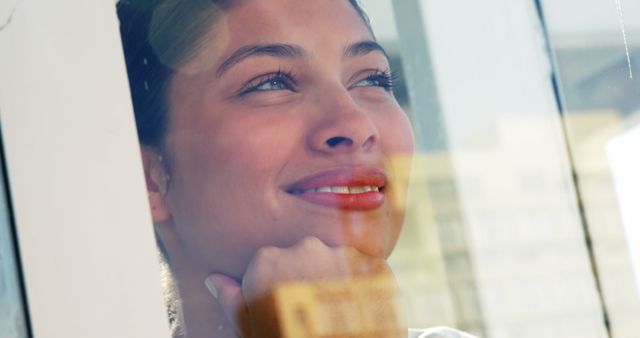 Pensive Woman Gazing Out of Window in Natural Light - Download Free Stock Images Pikwizard.com