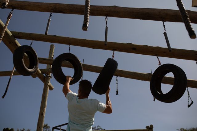 Fitness Coach Training on Jungle Gym with Tires - Download Free Stock Images Pikwizard.com