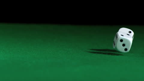 Slow Motion Dice Rolling Over Green Tabletop