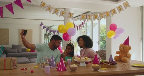 Diverse Family Celebrating Birthday at Home with Selfie and Decorations