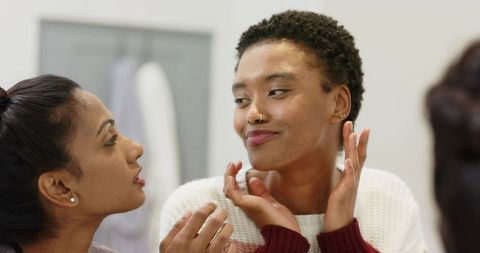 Diverse Female Friends Enjoying Close Conversation Indoors