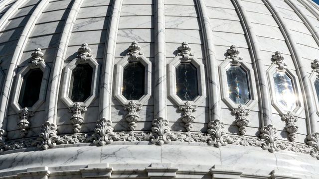 Ornate marble dome detail with octagonal windows, ribbed segments and carved scrollwork