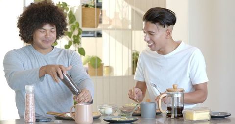 Friends preparing avocado toast together in modern kitchen