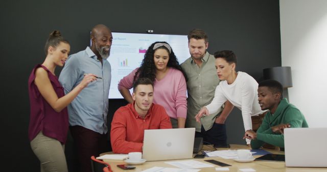 Image shows a group of diverse business professionals actively participating in a meeting within a sleek, modern office environment. Ideal for demonstrating workplace diversity, teamwork, and corporate culture in presentation materials, advertisements for corporate services, or HR manuals.